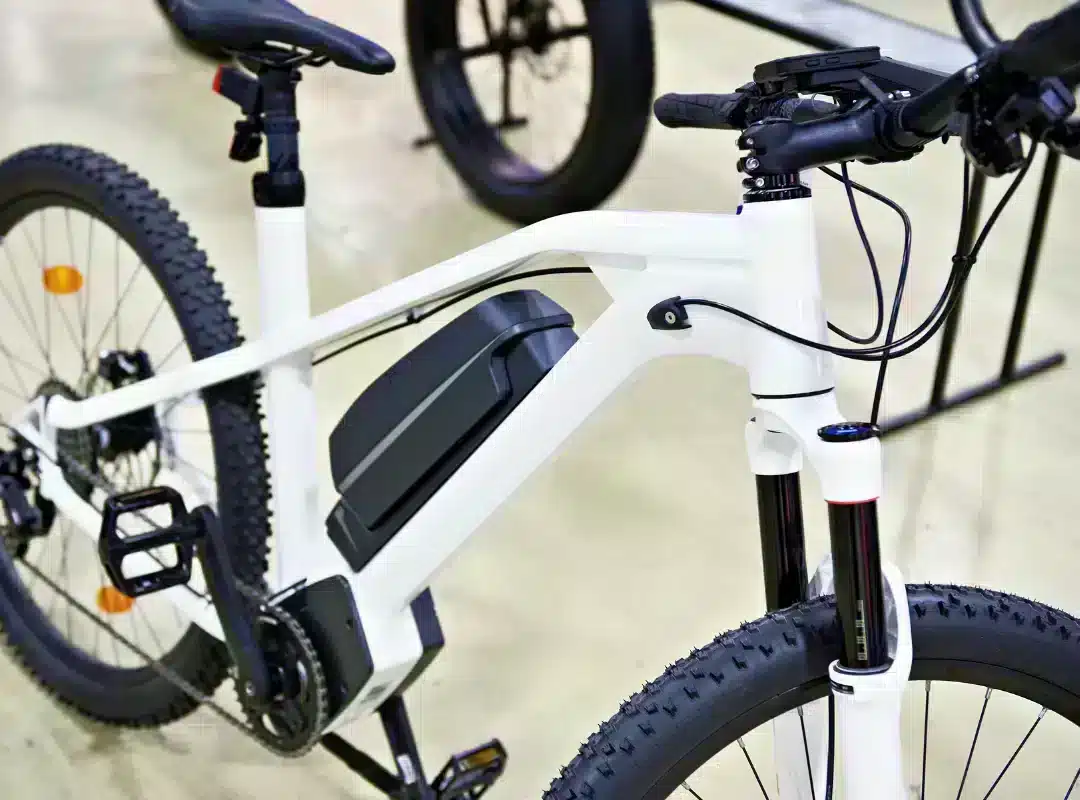 Witte elektrische fiets van onbekend merk met een trapeziumvormige accu op het frame.